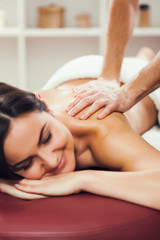 Young woman is enjoying massage on spa treatment. 
