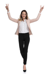 Obraz premium beautiful businesswoman walks and celebrates with hands in the air