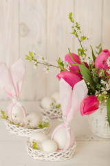 Happy easter. Decor of Easter eggs in small white baskets.