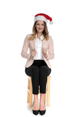 happy santa claus businesswoman sitting  and pulls collar