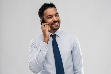 business, office worker and people concept - smiling indian businessman calling on smartphone over...