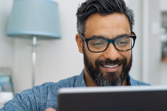 Latin Man Using Digital Tablet