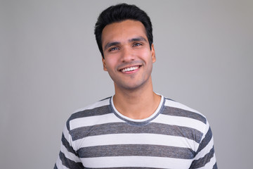 Portrait of happy young handsome Indian man