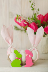 Happy easter. Decor of Easter eggs - napkins in the form of ears of Easter rabbits.