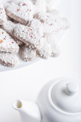  Valentine's day white coconut heart shaped cookies with red and pink heart sprinkles. Copy space