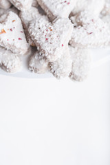  Valentine's day white coconut heart shaped cookies with red and pink heart sprinkles. Copy space