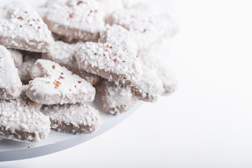 Valentine's day white coconut heart shaped cookies with red and pink heart sprinkles. Copy space
