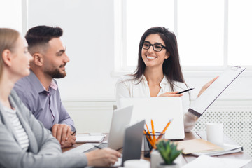 Fototapeta premium Businesswoman showing good statistics report at meeting