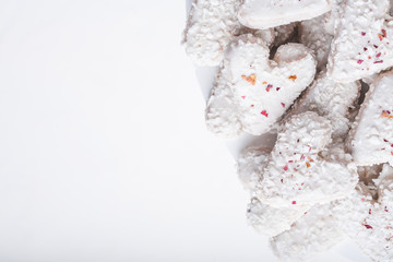  Valentine's day white coconut heart shaped cookies with red and pink heart sprinkles. Copy space