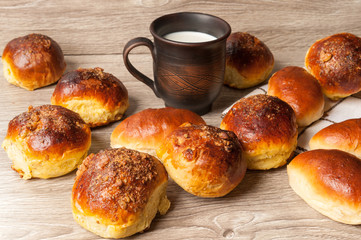 buns and pie and clay glass with milk