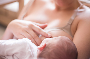 Fototapeta na wymiar Young mother using nursing bras breast while feeding