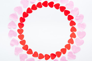 top view of round frame made with red and pink paper hearts isolated on white, st valentines day concept