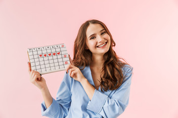 Beautiful young woman wearing pajamas standing