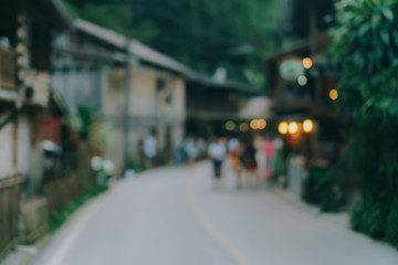 Blur street small village in mountain evening time  with people relax and chill out on vacation day.