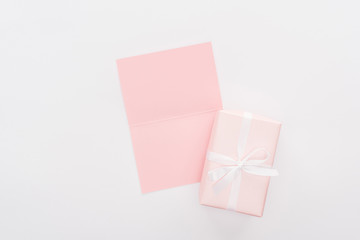 top view of pink gift box and empty card isolated on white