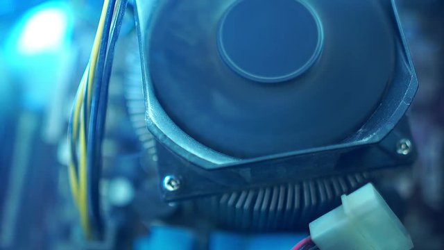 PC components in dust. Extra close-up CPU fan. Dust flies around. He starts to work