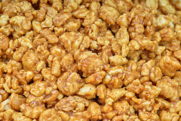 Sweet background and texture, nuts in caramel, close-up