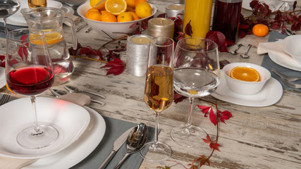 Rustic table setting with pink flowers and candle on light wooden table. Holidays decoration on Provence style. Romantic dinner. Overhead