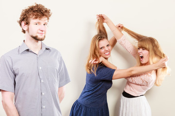 Aggressive mad women fighting over man.