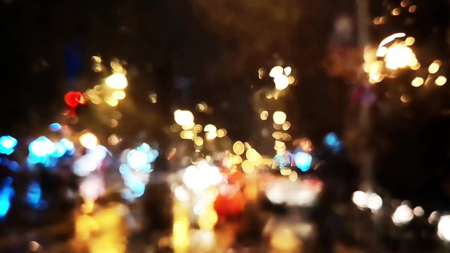 Defocused footage with cars and city lights in traffic.