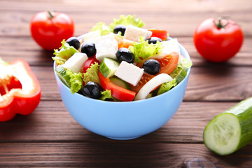 Fresh vegetable salad on grey background