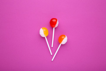 Colorful lollipops on pink background. sweet candy concept