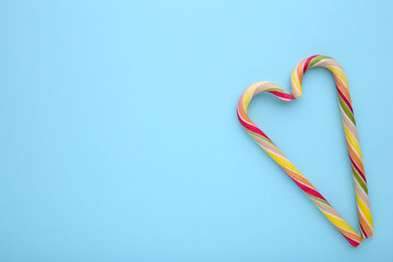Fototapeta premium Colorful lollipops on blue background. sweet candy concept