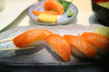 Selective focus of salmon nigiri sushi with chopsticks. Famous Japanese food. Food concept. 