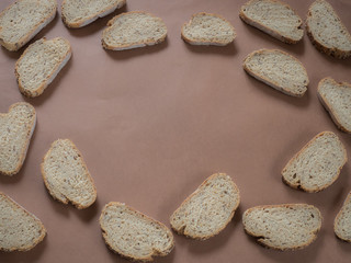 Bread with seeds pattern on brown background with copy space