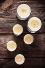 scented candles on old wooden background