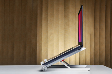 Laptop stand desk dock holder with notebook.