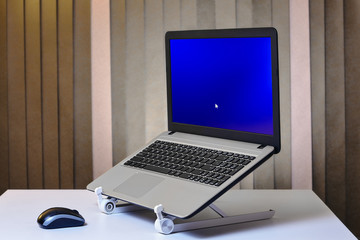 Laptop is started and installed on cooling stand.