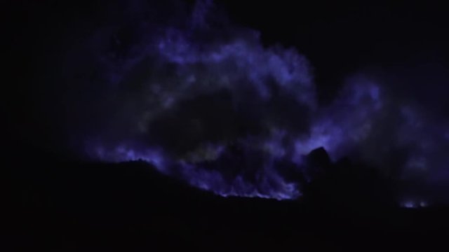 Blue fire of burning sulfur in a crater of a volcano Kawah ijen, Java, Indonesia. Famous tourist attraction, where sulfur is mined. Ijen volcano complex is a group of stratovolcanoes in the Banyuwangi