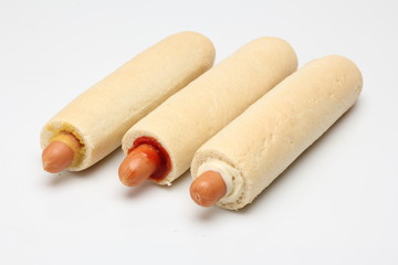 Hot dogi.  Hot dog z ketchupem, z musztardą i z sosem czosnkowym na białym tle. - obrazy, fototapety, plakaty