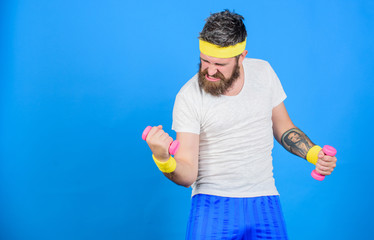 Athlete amateur workout. Athlete training with little dumbbell. Man bearded athlete exercising...