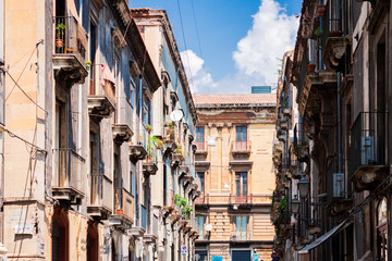 Travel to Italy -  historical street of Catania, Sicily, facade of ancient buildings.