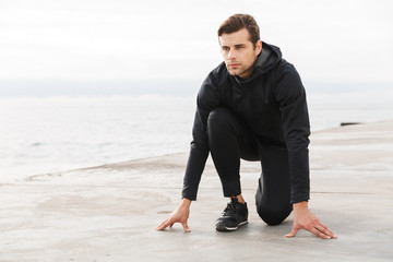 Handsome confident young sportsman working out