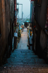 Naklejka na ściany i meble An stairway alley after a rainy evening
