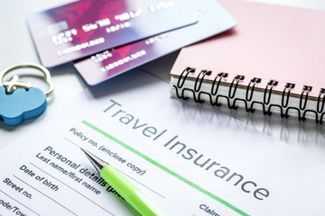 Fototapeta premium Travel insurance application form on white desk background