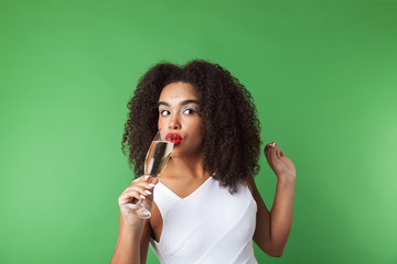 Obraz premium Cheerful young african woman wearing dress celebrating