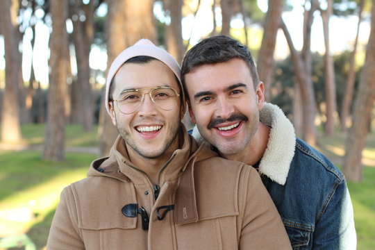 Trendy homosexual couple smiling outdoors