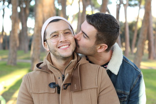 Trendy homosexual couple smiling outdoors