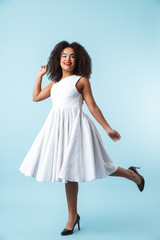 Full length of a happy african woman wearing dress