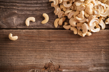 Roasted cashews on natural wooden table background