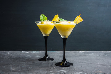 Freeze pineapple cocktail in martini glass. Selective focus. Shallow depth of field.