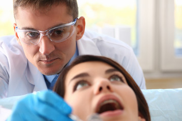 A woman at the reception of a male dentist
