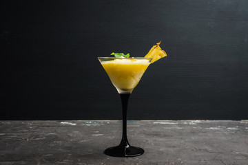 Freeze pineapple cocktail in martini glass. Selective focus. Shallow depth of field.