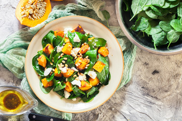 Roasted pumpkin salad with spinach and nuts
