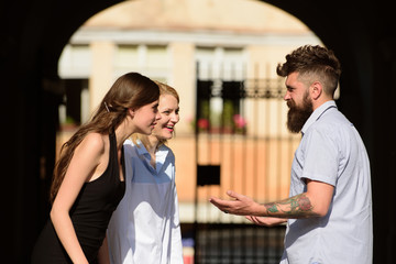 Friends meeting. Happy friends. Bearded man and pretty women smiling on street. Boyfriend dating girlfriends. People enjoying each others company. Bonds of friendship. Friendship begins with smile