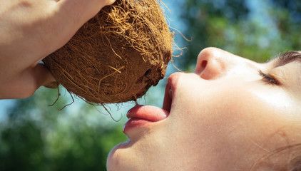 Clean eating diet, vegetarian and vegan. Woman is moisturizing her skin with a coconut cream....
